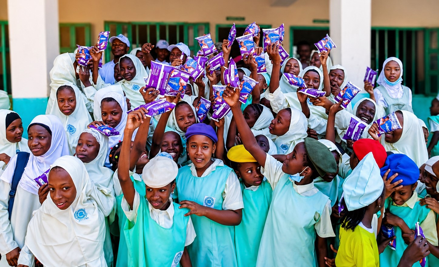 Students displaying menstrual health materials during a TIJCEF school programme